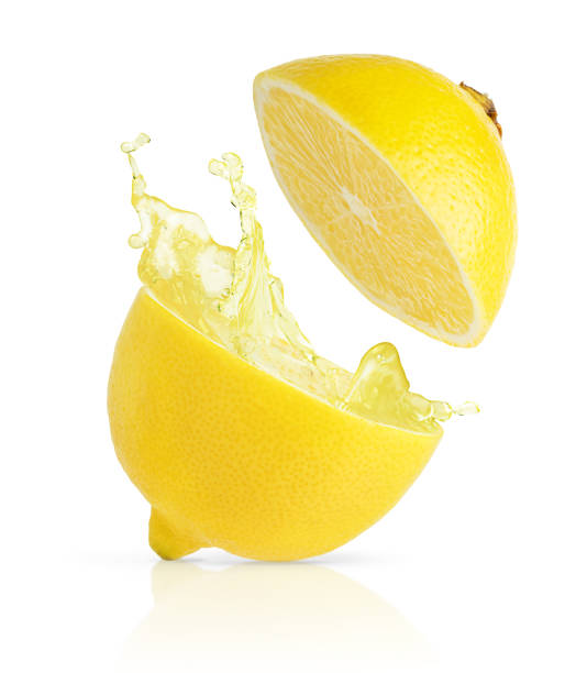 istock Cut lemon with splashing juice isolated on white background with clipping path. 1438212817