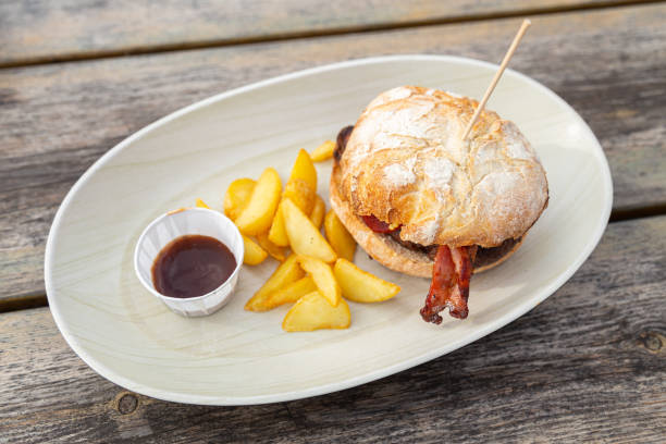 istock Hamburger with fries on a wooden table 1438213594