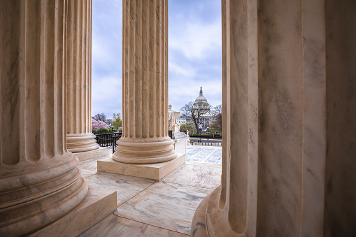 United States Supreme court marble pillars and US Congress cupola view, Washington DC, USA