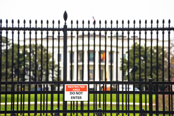 istock White House back garden iron fence and security warning view 1438213733