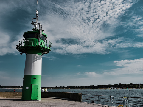 Closeup of the green and white lighthouse in Lubeck, Travemunde, Germany