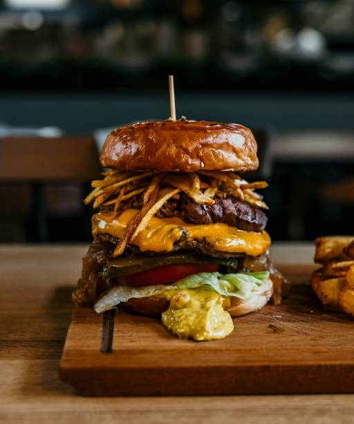 istock Vertical shot of an appetizing double-sized burger at a restaurant 1438214728