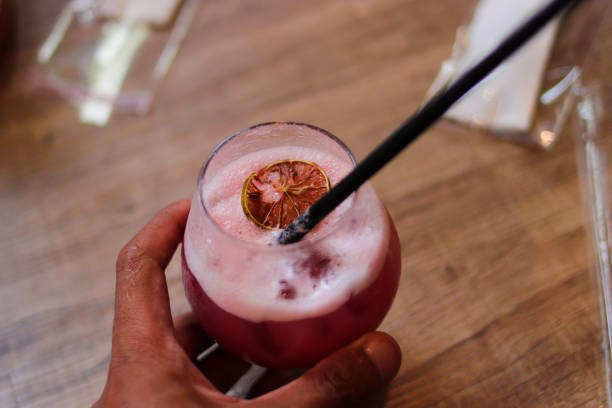istock Hand holding a middle eastern drink at the restaurant table. 1438214837