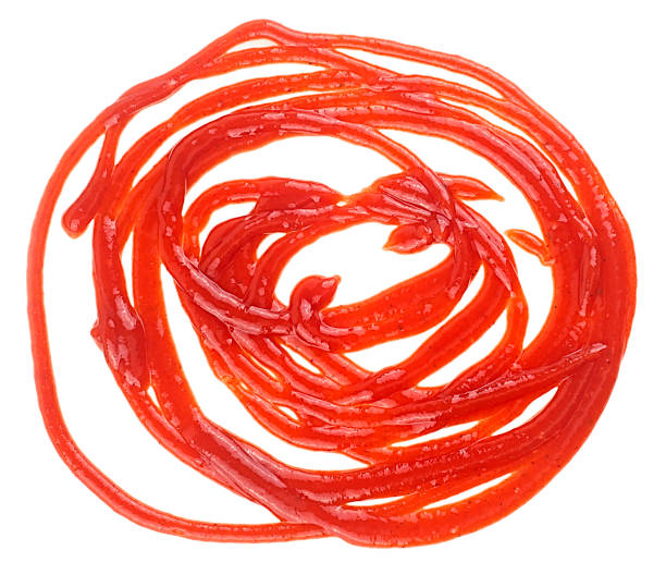 istock Red ketchup splash isolated on a white background, top view. Tomato puree, round texture. 1438214970