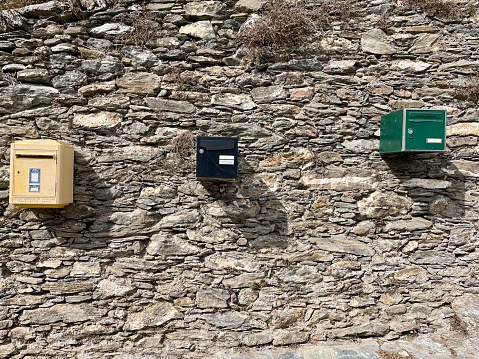 Row of colorful letter boxes in Monacia-d'Orezza, a dreamy hilltop village nestled in the mountains of Castagniccia, Corsica, France.