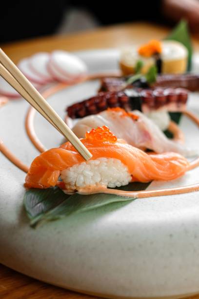 istock Closeup of garnished seafood on a white plate 1438218361