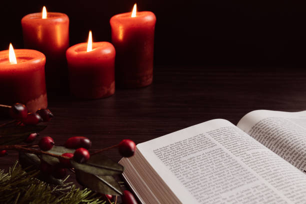 istock Open bible and four red Christmas candles 1438218514