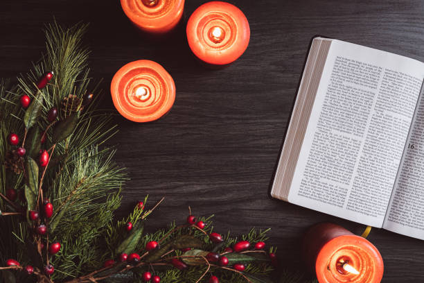 istock Bible, candles and evergreen border from above 1438218530