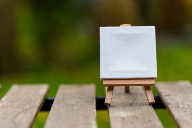 istock Closeup of a tiny canvas with space for text on a stand on a wooden surface 1438218643