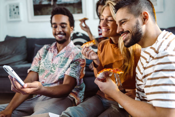 istock Group of young people hanging out at home and using smart phone 1438220607