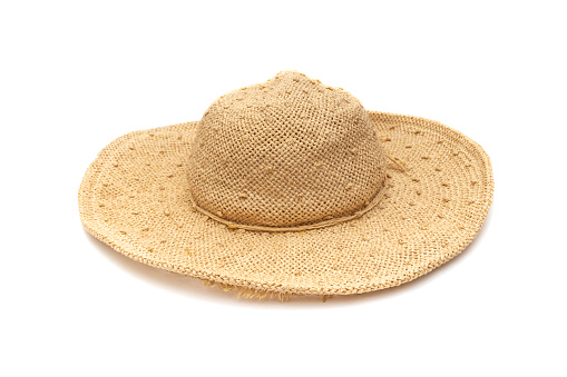 A beautiful wide-brimmed sun hat to effortlessly stay beautiful and shaded at the beach or poolside. Isolated on white background.