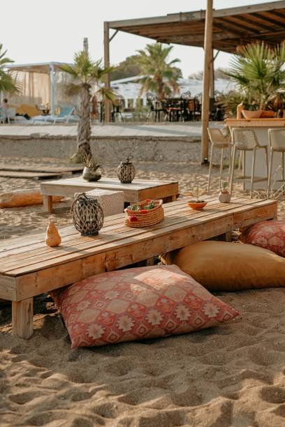 istock Vertical shot of a cafe on sand with pattern cushion and wooden table 1438221870