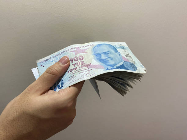 Turkish banknotes, Turkish money, Turkish lira, a hand holding Turkish banknotes stock photo