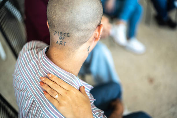 istock Close-up of a hand on shoulder on a group therapy 1438222326