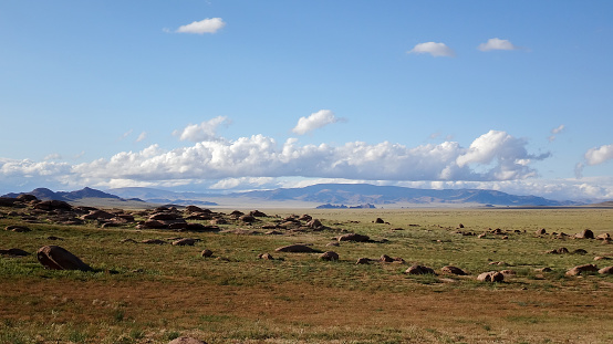 landscape of outdoor wild field with mountains at horizon