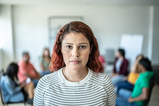 Portrait of mid adult woman in a meeting at community center