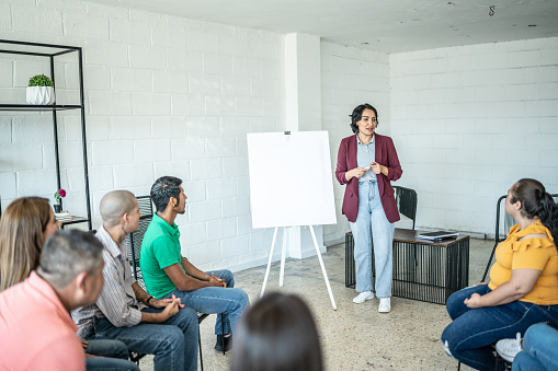 Mid adult woman doing a presentation during a meeting