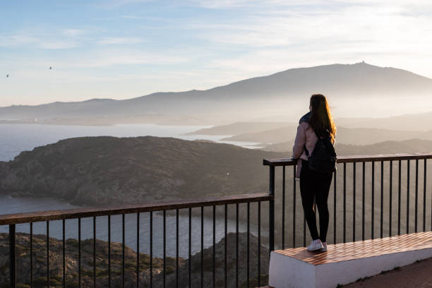 istock Beautiful women standing at a viewpoint on a cliff during sunset 1438226294