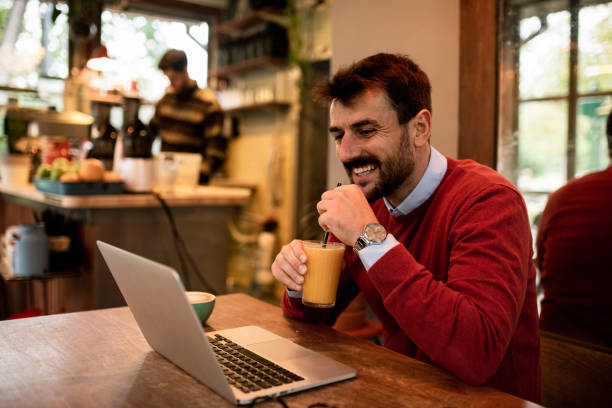 istock Attractive young freelancer on a video call in a coffee shop 1438227301
