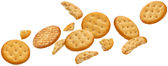 Falling round cheese crackers isolated on white background with clipping path