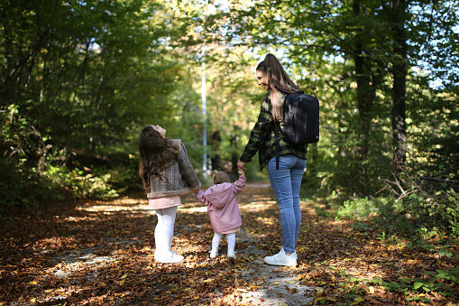 Mom is a special person. Mother and daughters in nature.