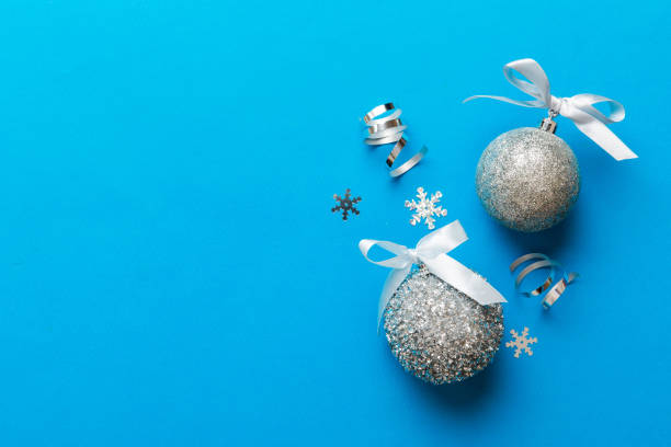 istock Christmas ball on colored background. decoration bauble with ribbon bow with copy space 1438231071