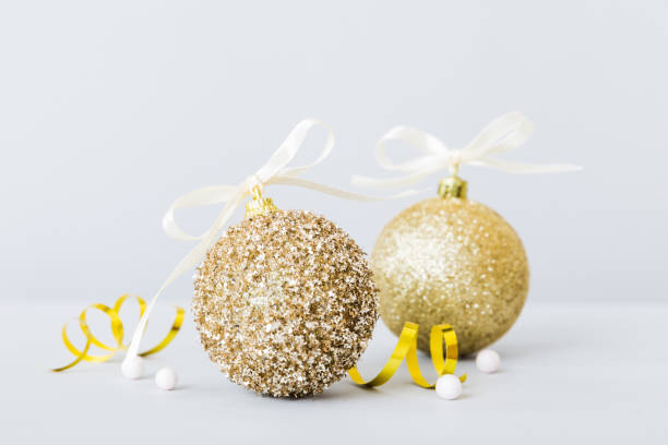 istock Christmas ball on colored background. decoration bauble with ribbon bow with copy space 1438231130