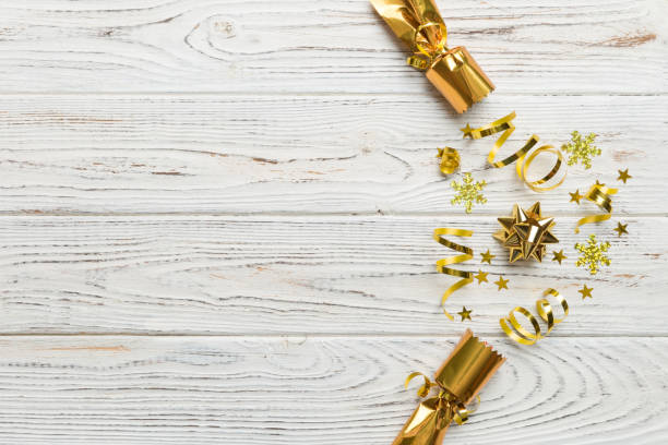 istock Christmas crackers with shiny confetti on color background, top view, copy space 1438231168