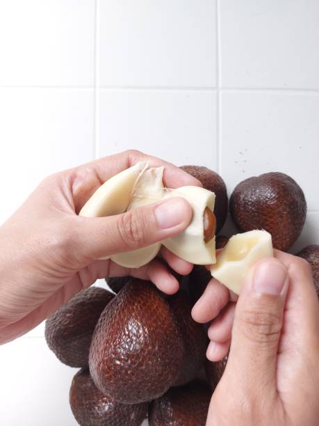 istock women hand peeling the salak fruit or snakefruits. 1438231183