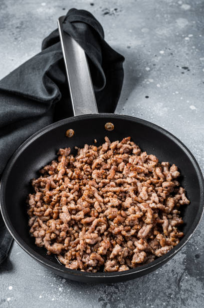 istock Pan fried minced meat to Italian pasta. Gray background. Top view 1438232322