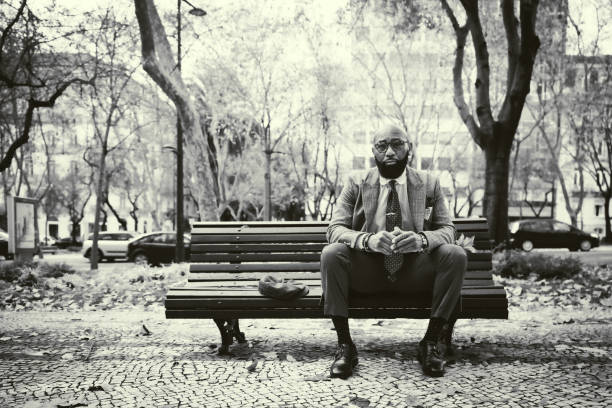 Black businessman on a wooden bench