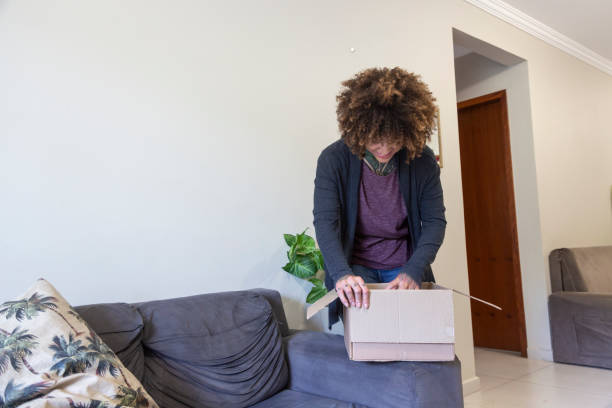 istock Black woman at home with order she ordered over the internet 1438244127