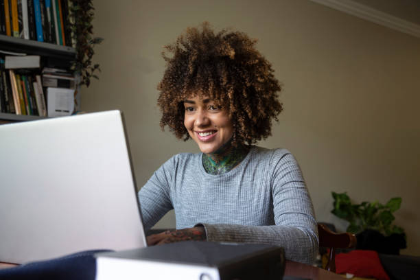 istock Black woman studying with laptop at home 1438244206
