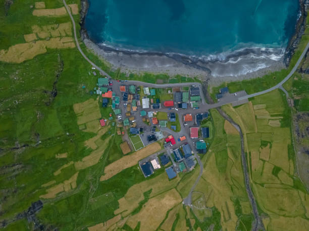Beautiful aerial view of the Tjornuvik village in the middle of the Mountains in Faroe Island Beautiful aerial view of the Tjornuvik village in the middle of the Mountains in Faroe Island eysturoy stock pictures, royalty-free photos & images