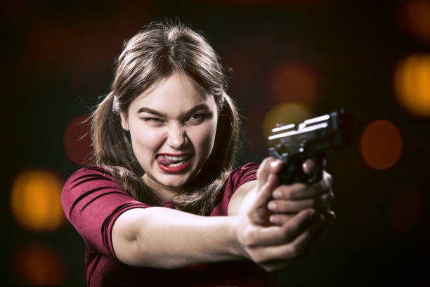 istock girl with gun 1438246938
