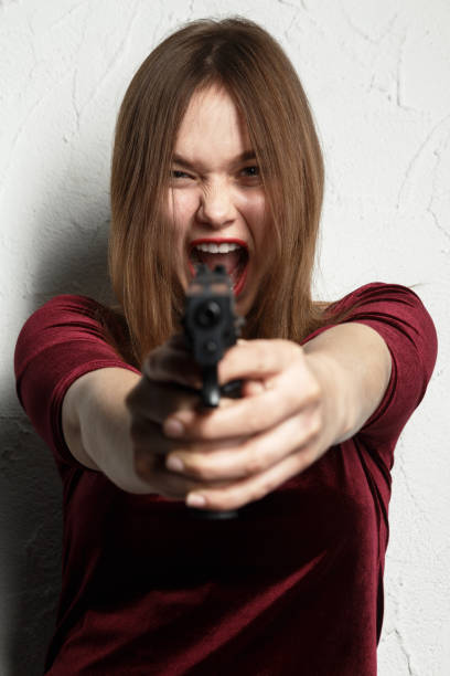 istock girl with gun 1438248091