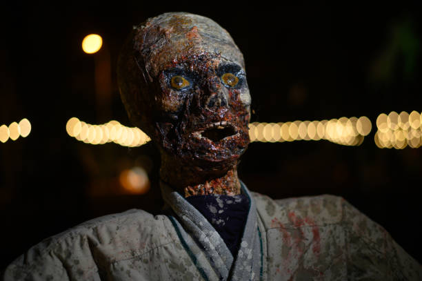 Horror zombie dummy as Halloween decoration in darkness