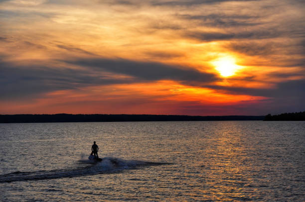 istock Jet skier driving off into the sunset 1438250920