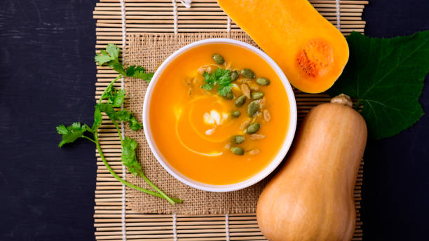 Butternut squash pumpkin soup in bowl stock photo