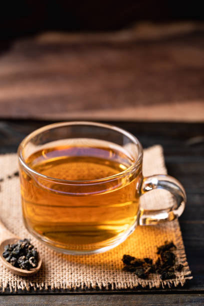 istock Hot tea in cup glass with dried tea leaves 1438251686