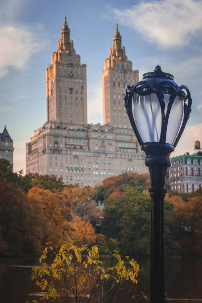 Central Park in Fall with towers on Central Park West. Classic Central Park lantern in the foreground