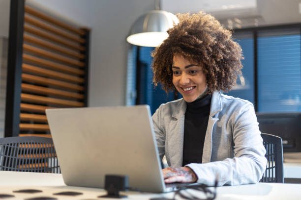 istock Black woman working with laptop in an office 1438254183