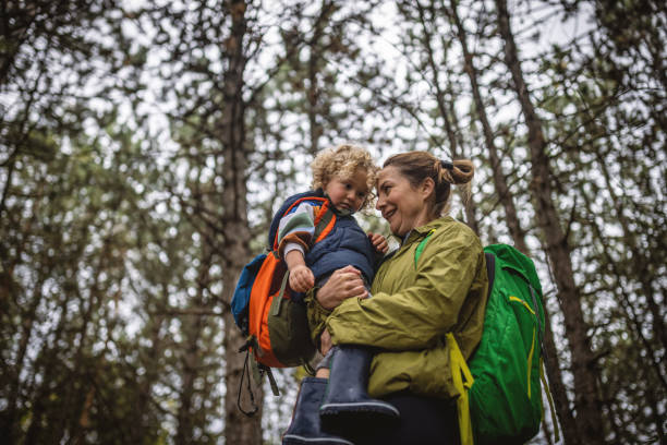istock Mother and son spending autumn day in a forest 1438257853