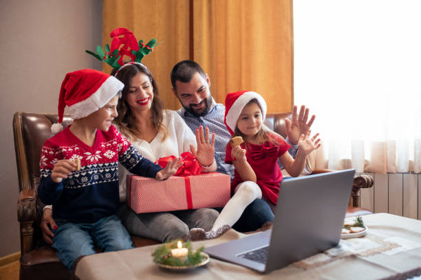 istock Happy family on Christmas having a video conversation. 1438258729