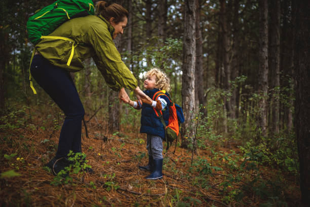 istock Mother and son spending autumn day in a forest 1438258773