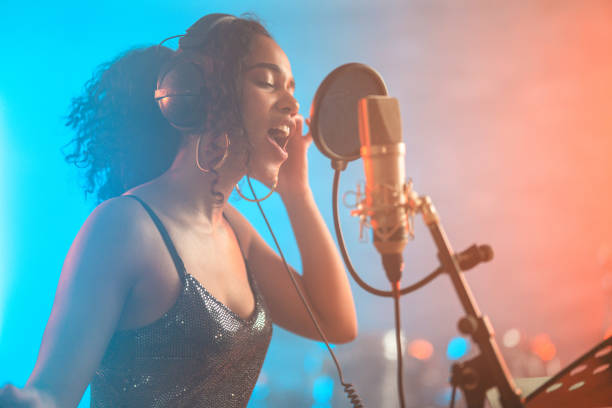 istock Engaged Hispanic Young Singer in Recording Studio 1438260334