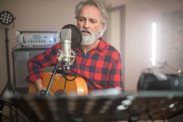 istock Senior Caucasian Guitarist Playing Classical Guitar in Recording Studio 1438260364
