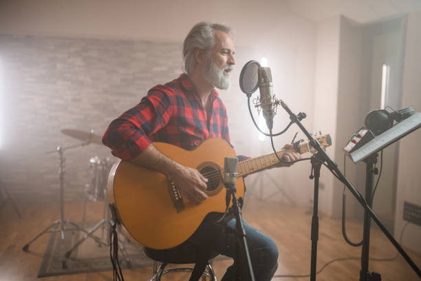 istock Senior Caucasian Guitarist Playing Classical Guitar in Recording Studio 1438260366