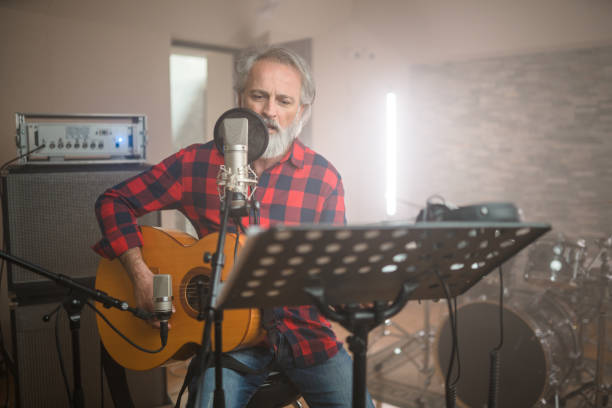 istock Senior Caucasian Guitarist Playing Classical Guitar in Recording Studio 1438260368