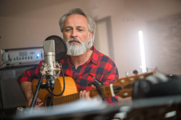 istock Senior Caucasian Guitarist Playing Classical Guitar in Recording Studio 1438260378